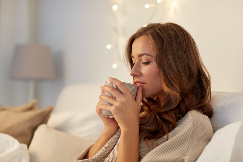 tenant having drink on sofa